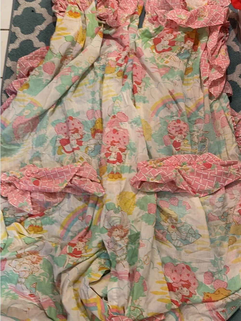 Vintage 1980 Strawberry Shortcake bedspread and pair of curtains with ties.